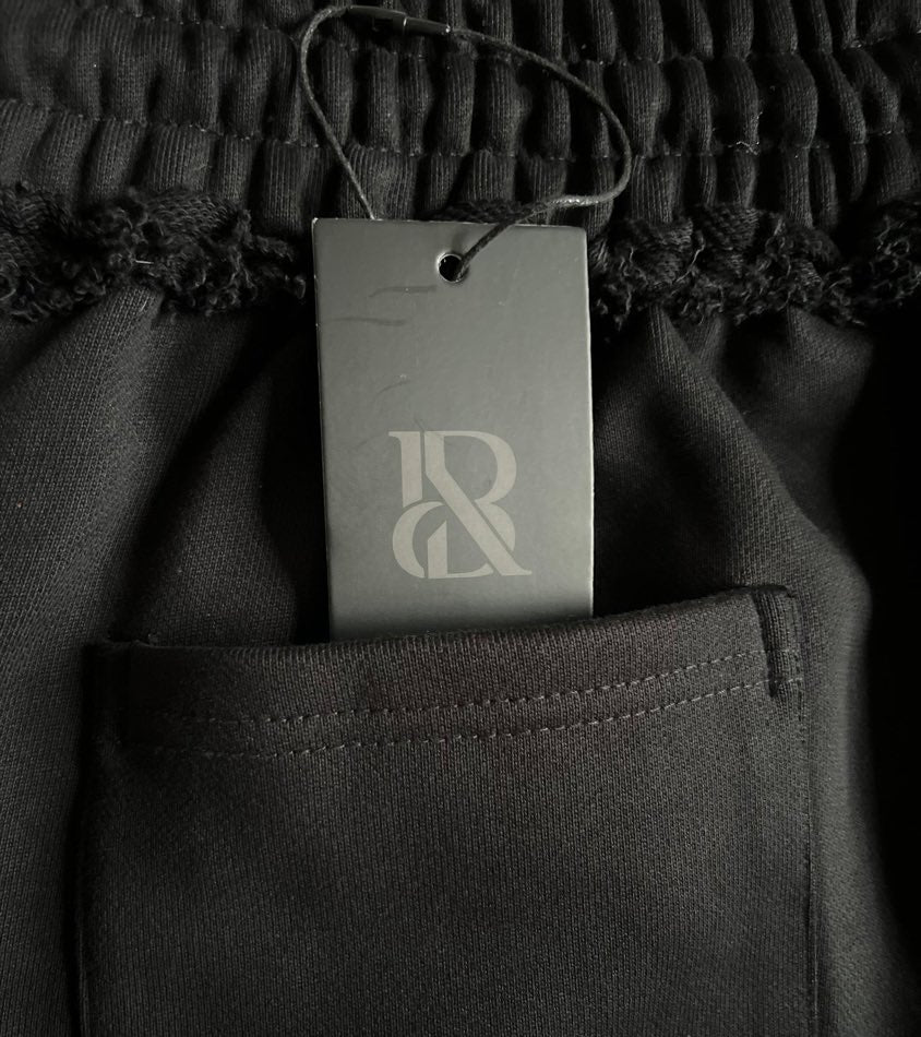 The monogram hangtag tucked into the back patch pocket, still attached.